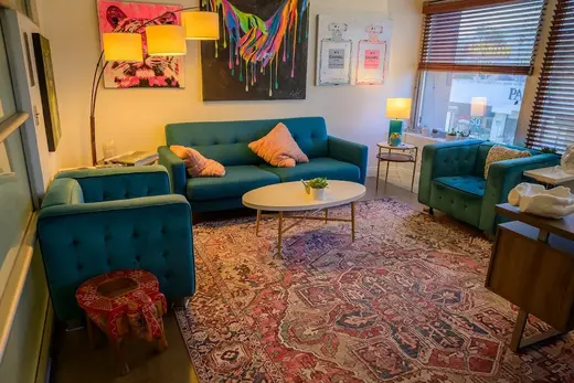 Cozy sitting area with teal sofas at Westwind Recovery, an intensive outpatient program in Los Angeles.