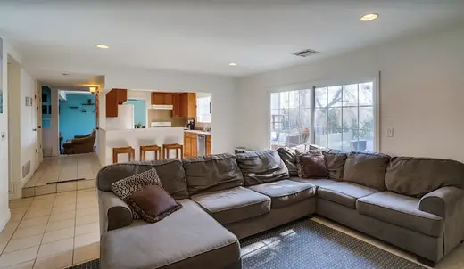 Spacious living room with sectional sofa at Design For Recovery, a sober living home in Los Angeles.