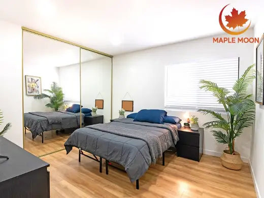 Cozy bedroom with mirrored closet at Maple Moon Recovery, a sober living home in Los Angeles.