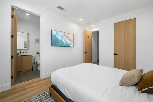Cozy bedroom with a bed and modern decor at Refine Recovery, a treatment center in Los Angeles.