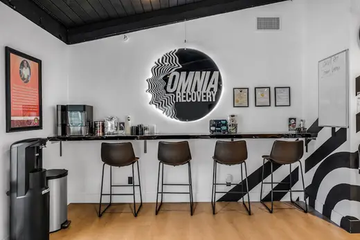 Modern reception area with bar seating at Omnia Recovery, addiction & mental health treatment center in Los Angeles.
